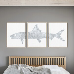 May include: Three framed prints of a stylized blue fish with a white background. The fish is made up of a series of thin, parallel lines.
