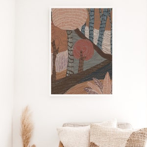 May include: Abstract art print featuring a stylized forest scene with brown, pink, and blue trees. The print has a textured, hand-drawn look.