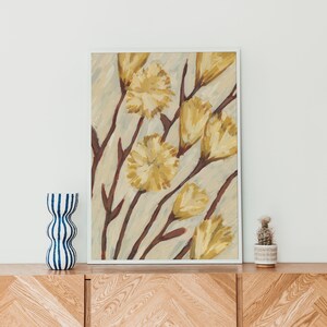 May include: A framed painting of yellow flowers with brown stems on a light beige background.