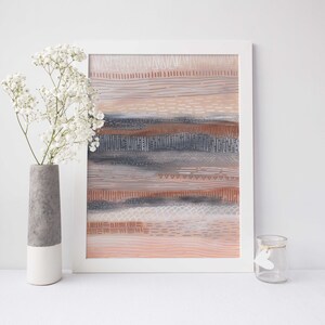 May include: A framed abstract painting with a white frame. The painting features a layered design of horizontal lines and patterns in shades of pink, brown, gray, and white.