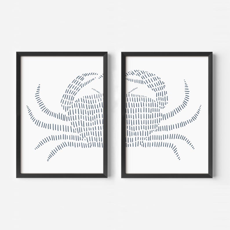 May include: Two black framed prints of a stylized crab design in blue on a white background.
