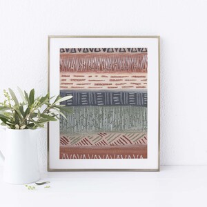 May include: A framed print with a geometric pattern in shades of brown, green, and gray. The pattern is made up of lines, triangles, and squares.