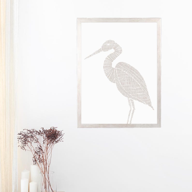 May include: A framed print of a white heron with a detailed line drawing design. The heron is standing on one leg with its head turned to the side.