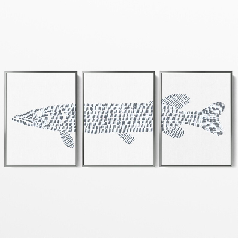 May include: A set of three framed prints featuring a stylized line drawing of a fish in shades of blue on a white background.