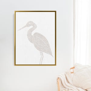 May include: A framed print of a white heron with a detailed line drawing design. The heron is outlined in a light brown color and is set against a white background.