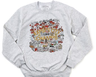 May include: A gray sweatshirt with a colorful illustration of the Kansas City Chiefs Super Bowl LVII victory. The illustration includes players, coaches, and other details related to the team's win.
