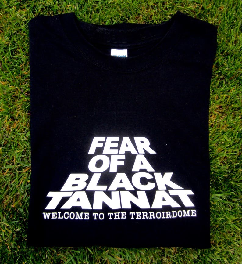 May include: Black t-shirt with white text that reads "Fear of a Black Tannat, Welcome to the TerroirDome".