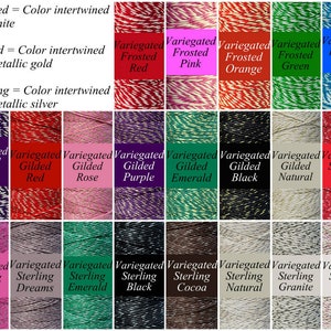 May include: Assortment of 16 spools of variegated twine. The twine is available in a variety of colors, including red, pink, orange, green, blue, purple, emerald, black, natural, and silver. The twine is labeled with the color and type of finish, such as "Frosted" or "Gilded".