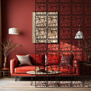May include: A black room divider with a geometric pattern. The divider is made of wood and has a modern design. It is placed in front of a red wall and a red sofa with pillows.