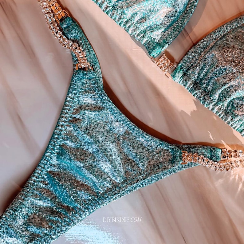 Competition Bikini bottoms on a marble table and rhinestone connectors, showing how bikinis made with this pattern turn out.