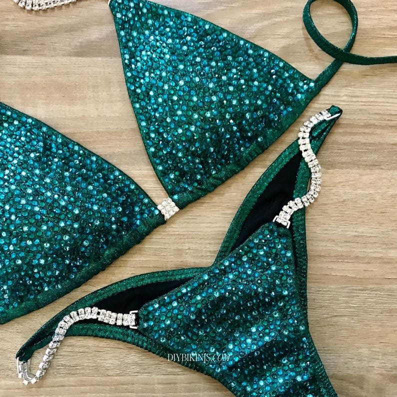 Green Bikini on a table, with silver crystal connectors and a brazilian back coverage included in this sewing pdf pattern for competition bikinis.