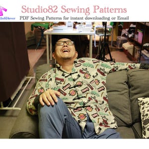 May include: A person wearing a light green patterned shirt with red and black accents, sitting on a gray couch. The shirt has a unique design with various graphic elements. The image also includes text that reads "Studio82 Sewing Patterns".