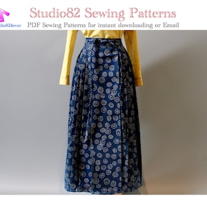 Peut inclure: Une longue jupe bleu marine avec un motif en spirales blanches est présentée sur un mannequin. Elle est associée à un haut jaune à manches longues. Le texte "Studio82 Sewing Patterns" est également visible.