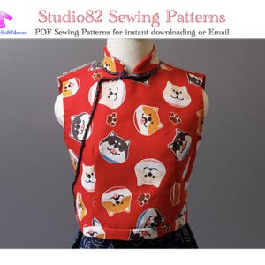 May include: A red vest featuring a pattern of cartoon dog faces and paw prints. The vest has a mandarin collar and black trim. The text "Studio82 Sewing Patterns" is visible at the top of the image.