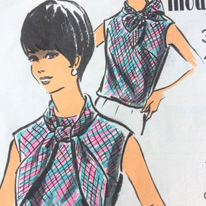 May include: A vintage sewing pattern for a sleeveless top with a large bow tie at the neck. The pattern features a checkered design in pink, blue and black.