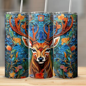 May include: A stainless steel tumbler with a colorful design featuring a deer with antlers surrounded by flowers and leaves. The design is reminiscent of stained glass.