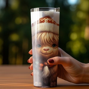 May include: A tall, clear tumbler features a whimsical illustration of an alpaca wearing a winter hat. The alpaca's fur is light brown and its expression is sweet and gentle. The hat is white with brown and orange patterns. The image is vibrant and detailed, suitable for a holiday-themed drinkware item. The tumbler is perfect for hot or cold beverages.