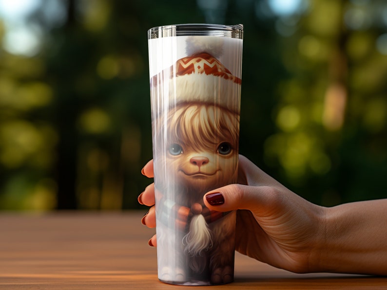 May include: A tall, clear tumbler features a whimsical illustration of an alpaca wearing a winter hat. The alpaca's fur is light brown and its expression is sweet and gentle. The hat is white with brown and orange patterns. The image is vibrant and detailed, suitable for a holiday-themed drinkware item. The tumbler is perfect for hot or cold beverages.