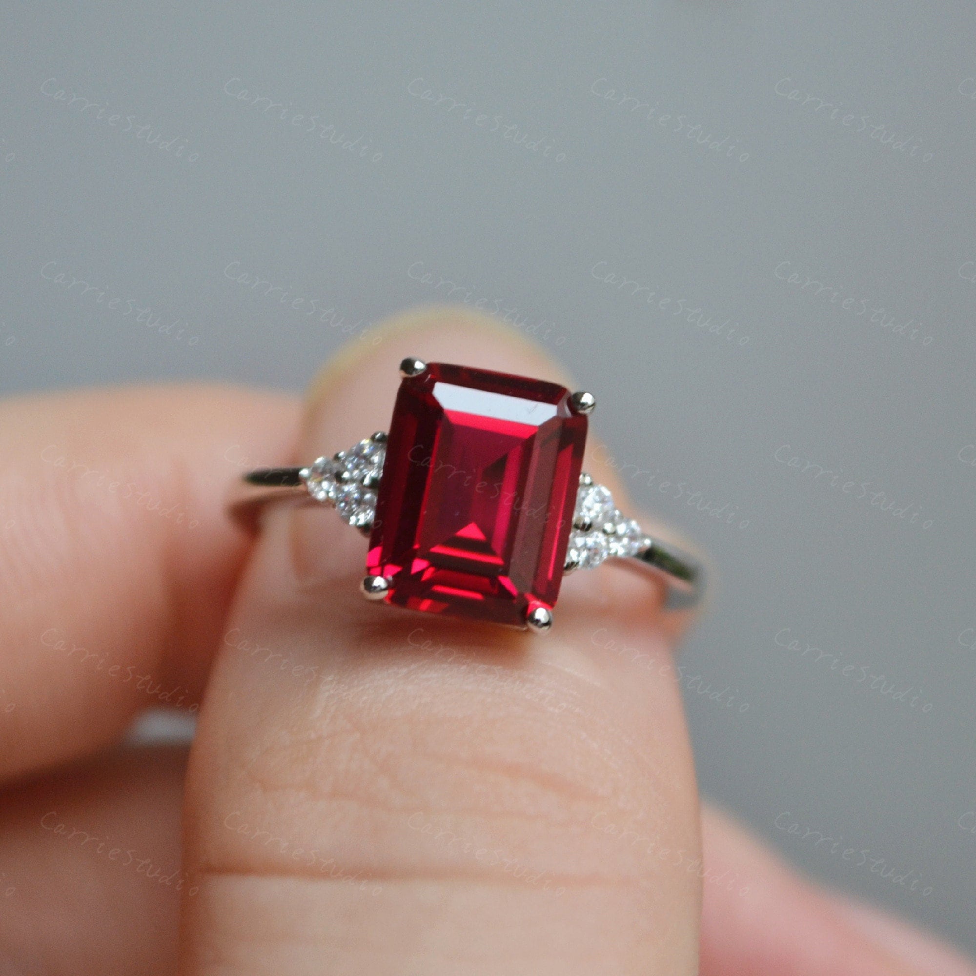 Exquisite platinum ring with emerald cut ruby -