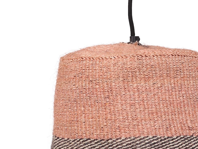 May include: A pink and brown woven pendant light fixture with a black cord.