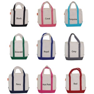 May include: Nine canvas tote bags with different colored trim. The bags are all white with orange handles and a small orange tag. The trim colors are black, coral, turquoise, emerald, royal blue, grey, navy, hot pink, and red.