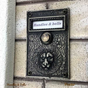 Solid Brass Doorbell Push Button with Bas Relief Lion Head in Pewter Finish.