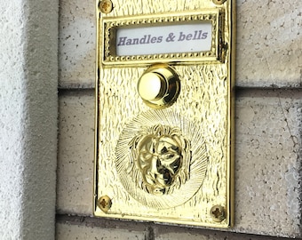 Solid Brass Doorbell Push Button with Bas Relief Lion Head in Polished Brass Finish.