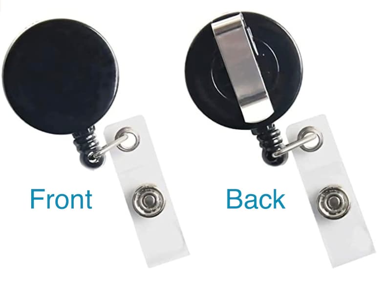 May include: Black retractable badge holder with a clip on the back and a clear plastic badge holder. The front of the badge holder has a black circle with a smooth surface. The back of the badge holder has a silver clip.