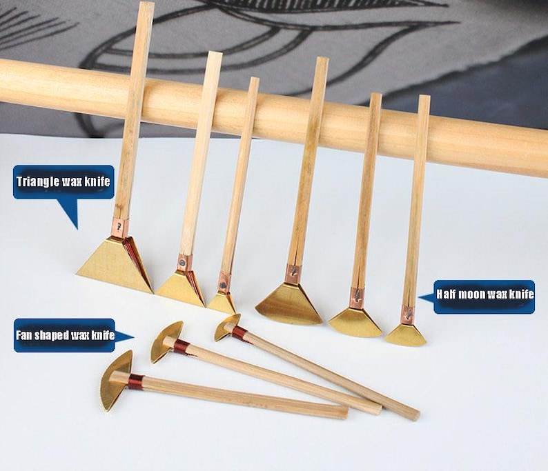 May include: A selection of wax knives with wooden handles and brass blades. The blades are in various shapes, including triangle, fan, and half-moon. The image text reads "Triangle wax knife", "Fan shaped wax knife", and "Half moon wax knife".