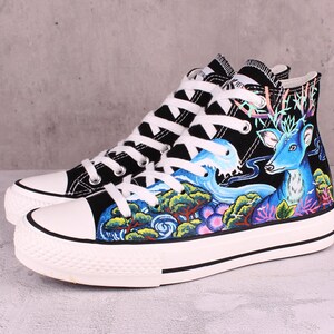 May include: Black high-top canvas sneakers with a hand-painted design featuring a blue deer, waves, and green trees.