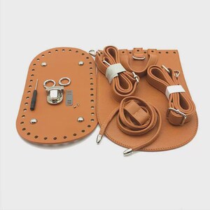 May include: A tan leather bag making kit including an oval base with pre-punched holes and metal feet, a main body piece, two adjustable straps, a drawstring cord, a metal turn-lock clasp, a small screwdriver, and various metal hardware components.