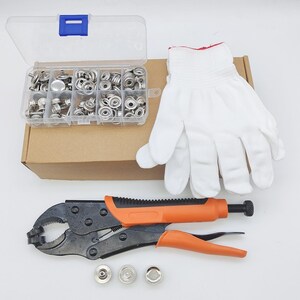 May include: A set of metal snap fasteners in a clear plastic divided storage box, a pair of white fabric gloves, and a black and orange locking plier tool. Three individual metal snap components are placed separately in front of the pliers.