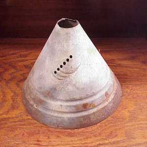 May include: A vintage galvanized metal cone-shaped funnel with a series of holes around the top edge. The funnel has a slightly rusted appearance.