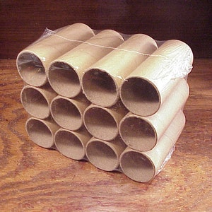 May include: A pack of 12 brown cardboard tubes, wrapped in clear plastic. The tubes are stacked in a rectangular shape.
