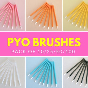 May include: A set of 10 disposable, single-use, white-tipped applicators in various colors: pink, orange, yellow, white, blue, and black. The applicators are arranged in a fan shape and labeled "PYO BRUSHES PACK OF 10/25/50/100".