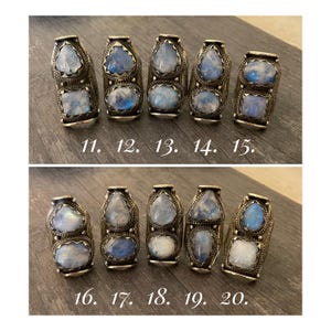 May include: Ten silver rings with moonstone settings. The rings are numbered 11 through 20.