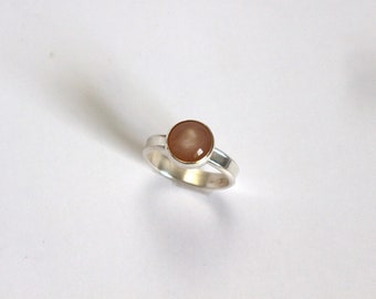Size 9 1/5 silver ring with a round peach moonstone