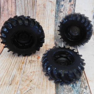 3D soap in the shape of a rugged black truck tire, featuring intricate details and realistic texture. The soap showcases distinct tread patterns, deep grooves, and a sturdy appearance, capturing the essence of a real truck tire.