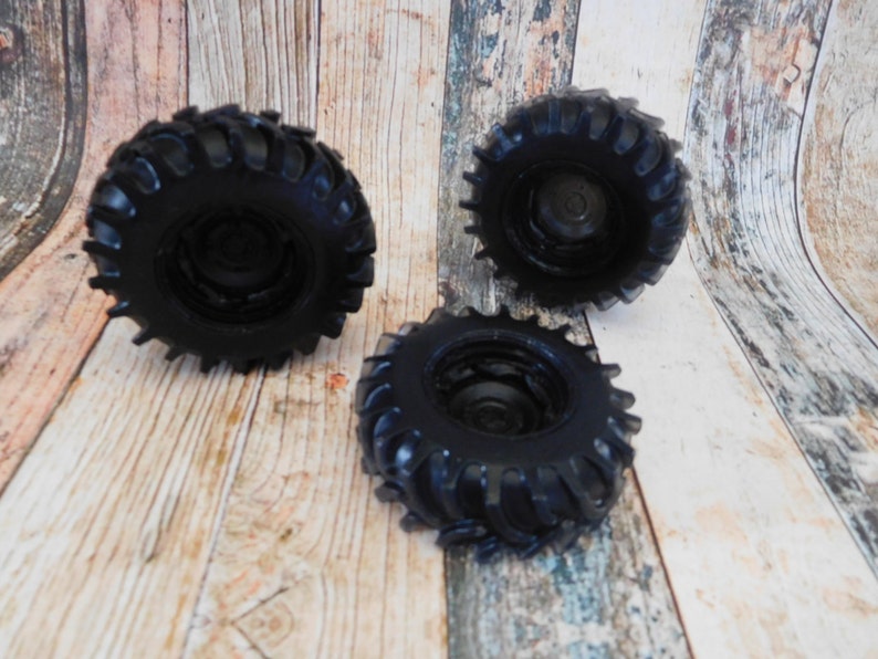 3D soap in the shape of a rugged black truck tire, featuring intricate details and realistic texture. The soap showcases distinct tread patterns, deep grooves, and a sturdy appearance, capturing the essence of a real truck tire.