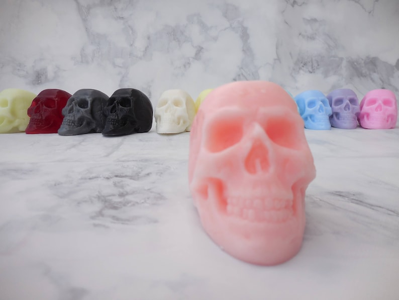 A row of 10 skull soaps in the background with a peach skull up front for close up image