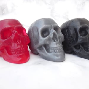 Three of our best selling colors of our 3-D skull soaps:  transparent red (clear red), gray, black.