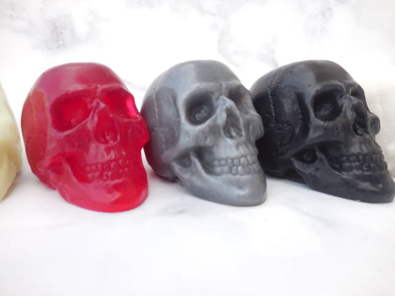 Three of our best selling colors of our 3-D skull soaps:  transparent red (clear red), gray, black.