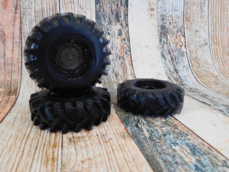 3D soap in the shape of a rugged black truck tire, featuring intricate details and realistic texture. The soap showcases distinct tread patterns, deep grooves, and a sturdy appearance, capturing the essence of a real truck tire.