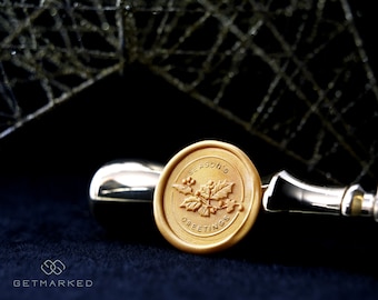 May include: A gold wax seal with the text "Season's Greetings" and a holly leaf design.