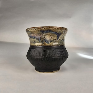 10 oz Viking cup.  Black and sand & stone with threads of blue glazing.  Handmade pottery. Anglo Saxon