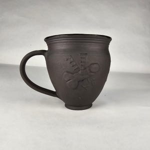 16 oz Flying "luck" mug black clay with black glazing.  Handmade pottery. Roman. Fascinus.