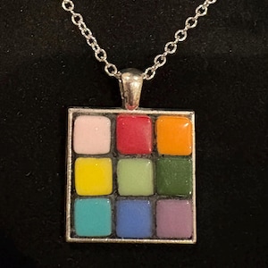 May include: A set of three ceramic mugs with a speckled, matte finish. The mugs are in shades of cream, light gray, and dark gray. Each mug has a simple, minimalist design and a rounded handle.