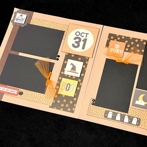 May include: A scrapbook page with a Halloween theme. The page is decorated with orange, black, and yellow paper, and features photos, stickers, and embellishments. The text on the page reads "Happy Halloween", "Oct 31", "So Spooky!" and "Best Day of the Year!"