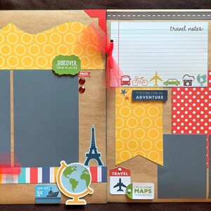 May include: A scrapbook layout with a travel theme. The layout features a brown background with red, yellow, and blue patterned paper. The layout includes a globe, a hot air balloon, a plane, and a car. The text "Adventure There" and "Travel Notes" is included in the layout.