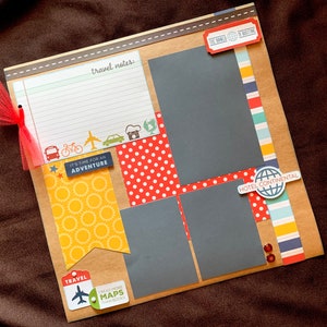 May include: A scrapbook page with a travel theme. It features a variety of patterned papers, including red and white polka dots, yellow with a sunburst pattern, and blue and white stripes. There are also several cutouts, including a plane, a bicycle, a camera, and a globe. The text on the page includes "It's time for an adventure", "Travel", "Read more maps than books", "The world is waiting", and "Hotel Continental".